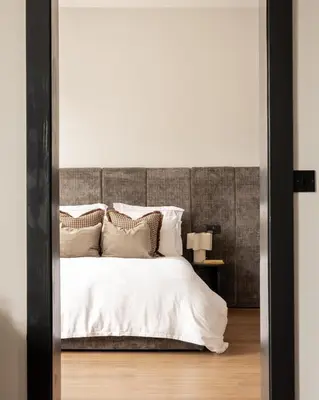 a bedroom with a large bed with white sheets and pillows at Moment Blythswood St in Glasgow