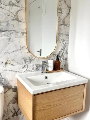 a bathroom with a sink and a mirror at Almondvale Apartment in Livingston