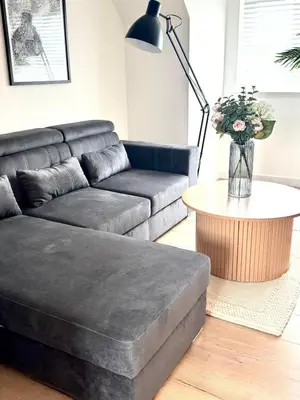 a living room with a couch and a table at Almondvale Apartment in Livingston