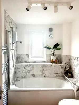 a white bath tub in a bathroom with a window at Almondvale Apartment in Livingston