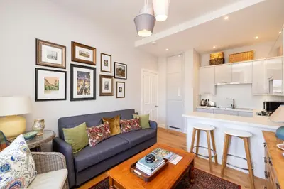 a living room with a couch and a table at Edinburgh Stockbridge Charm Apartment in Edinburgh