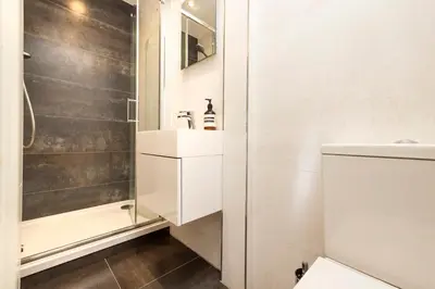 a bathroom with a sink and a shower at Edinburgh Stockbridge Charm Apartment in Edinburgh