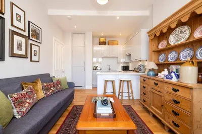 a living room with a couch and a table at Edinburgh Stockbridge Charm Apartment in Edinburgh