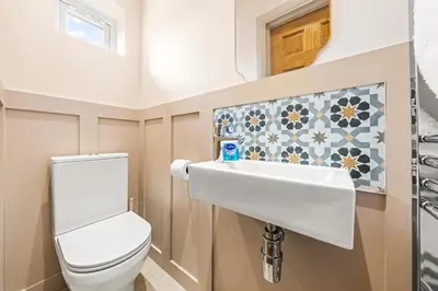 a bathroom with a toilet and a sink at Bright & Modern 3-Bed House Next To Glasgow Airport in Abbotsinch