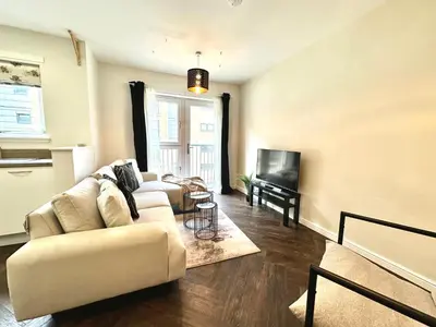a living room with two couches and a television at The Clyde Retreat, 2 Bedrooms in Glasgow