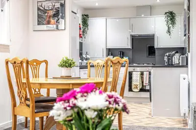 a kitchen and dining room with a table and chairs at Super Prime The City Residence in Dunfermline