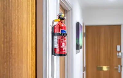 a fire extinguisher is hanging on a door at Super Prime The City Residence in Dunfermline