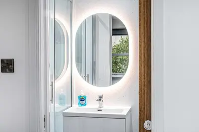 a bathroom with a sink and a mirror at Super Prime The City Residence in Dunfermline