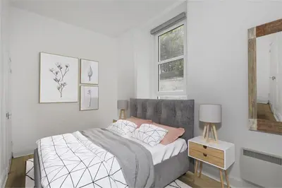 a white bedroom with a bed and a window at Haymarket Edinburgh Flat Sleeps 4 in Edinburgh
