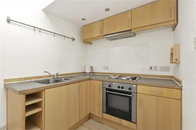 a kitchen with a sink and a stove at Haymarket Edinburgh Flat Sleeps 4 in Edinburgh