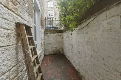 an empty alley with a window and a ladder at Haymarket Edinburgh Flat Sleeps 4 in Edinburgh