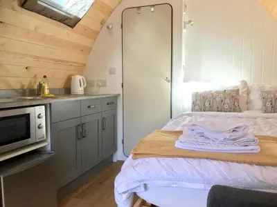 a kitchen with a bed and a microwave in a room at Queensland Holiday Park - Glamping in South West Scotland in Barrhill
