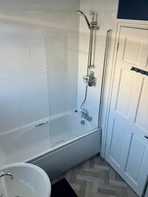 a bathroom with a tub and a toilet and a sink at Southsea Home with Free Parking in Moffat