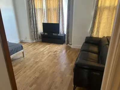 a living room with a couch and a flat screen tv at Flat in Moffat