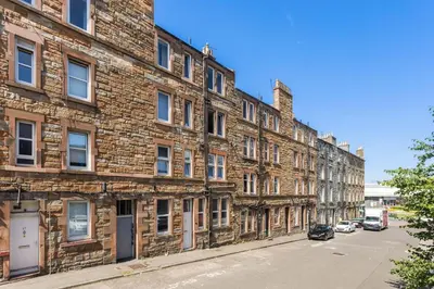 a row of brick buildings on a street at Sleek Canalside Stay in Edinburgh in Edinburgh