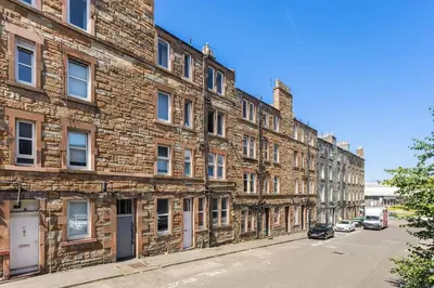 a row of brick buildings on a street at Sleek Canalside Stay in Edinburgh in Edinburgh