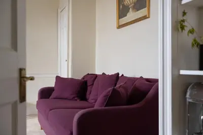 a purple couch sitting in a living room at Elegant Town house in Edinburgh in Moffat