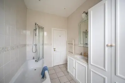 a white bathroom with a tub and a sink at Elegant Town house in Edinburgh in Moffat