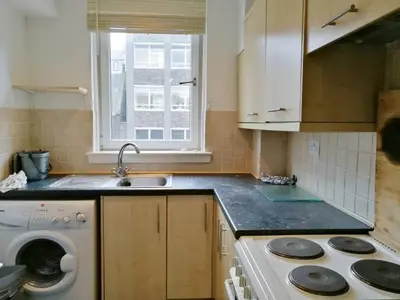 a kitchen with a sink and a washing machine at Glasgow Property New City Rd in Glasgow