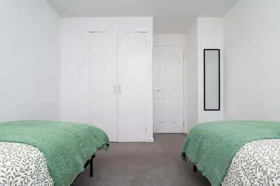 two beds sitting next to each other in a bedroom at 2 Bedroom Flat - Free Parking- by Holiday Homes in Clydebank