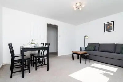 a living room with a couch and a table and chairs at 2 Bedroom Flat - Free Parking- by Holiday Homes in Clydebank