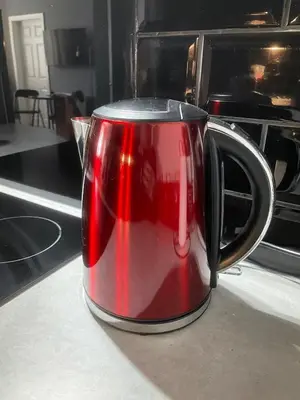 a red coffee pot sitting on a kitchen counter at Foundry Street Apartment 1 - Dunfermline City Centre in Dunfermline