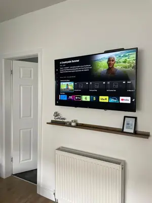 a flat screen tv hanging on a wall at Foundry Street Apartment 3 - Dunfermline City Centre in Dunfermline