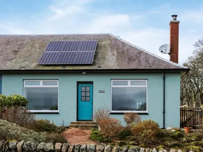 a house with solar panels on the roof at Bendhu in Mill of Fortune