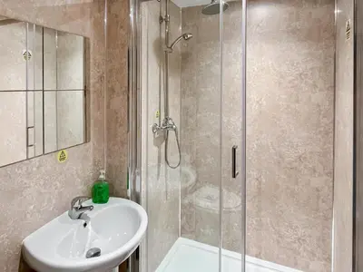 a bathroom with a sink and a shower at Homely Base in Crossgates