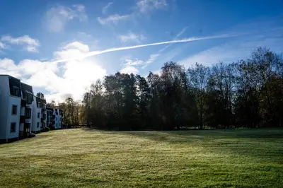 a large grass field next to a building and trees at 28 Guthrie Court - Gleneagles Village