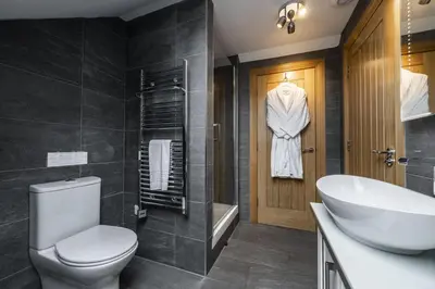 a bathroom with a toilet and a sink and a tub at The Keep in Kirknewton