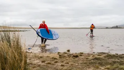 two people are standing in a body of water at The Keep in Kirknewton