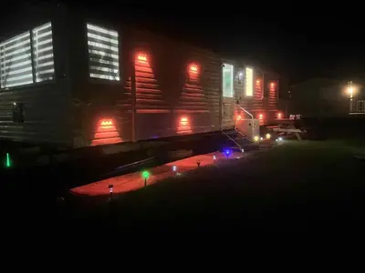 a train car with lights in the dark at the heaths caravan hire Craig Tara in Minishant