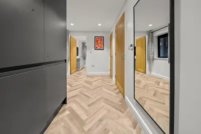 a hallway with wooden flooring in a building at The Salt Room Modern 1 Bedroom Home By AltoLuxo Short Lets Serviced Accommodation With Free Wifi & Parking in Moffat