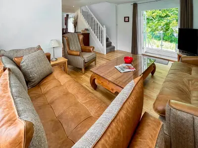a living room with a couch and a table at Riverview Cottage in Kenmore