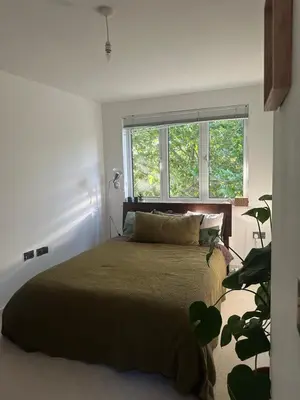 a bedroom with a large bed and a window at Central London in Moffat