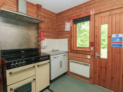 a kitchen with a stove and a window at Shore Lodge Brodick Castle in Brodick