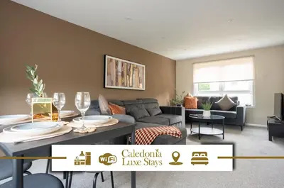 a living room with a couch and a table with wine glasses at Rise House in Livingston