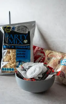 a bowl of food with a bag of chips and other snacks at Rise House in Livingston