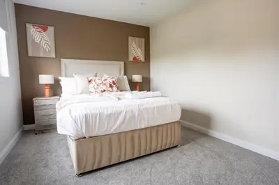 a bedroom with a large bed with white sheets and pillows at Rise House in Livingston