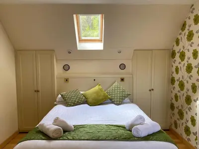 a bedroom with a large bed with towels on it at Inveraray, Loch Awe Rooms and Apartments in Portsonachan