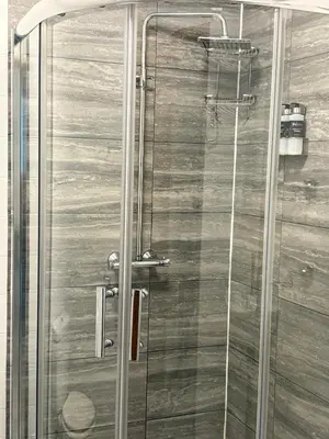 a shower with a glass door in a bathroom at Inveraray, Loch Awe Rooms and Apartments in Portsonachan