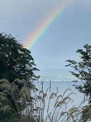 a rainbow in the sky over the water with trees at 2 Bed Flat - Sleeps 4 - Pets - Parking - Wifi in Rothesay