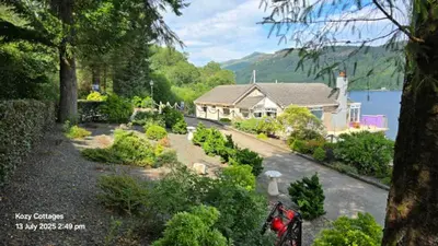 a house with a garden in front of a house at Jenny's Bay with Hot Tub in Lochgoilhead