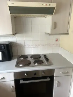 a stove top oven in a small kitchen at Serenity Space in Glasgow