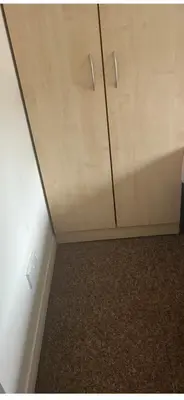 a cabinet in a room with a wall at Serenity Space in Glasgow