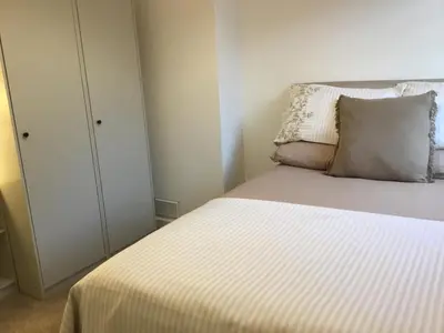 a bedroom with a bed with a pillow and a closet at West Highland Hideaway in Kinlochleven