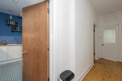 a room with a door and a kitchen with blue walls at Double Edinburgh Homestay in Edinburgh