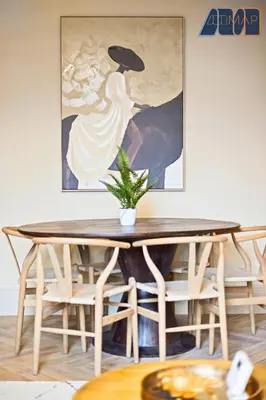 a dining room table with a painting on the wall at 3Bed Sleeps6 EdinburghCityCentre in Edinburgh
