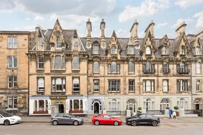 a large building with cars parked in front of it at 3Bed Sleeps6 EdinburghCityCentre in Edinburgh